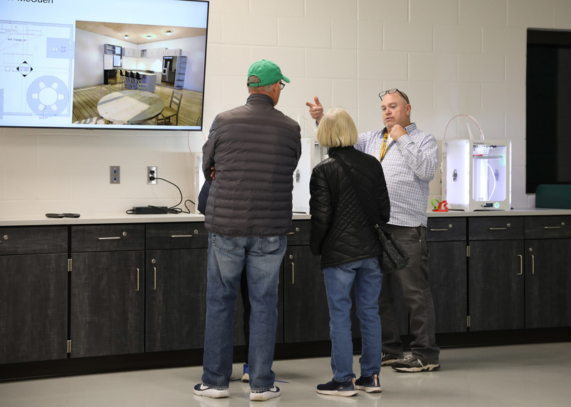 Engineering teacher Mike Dubois speaks to visitors during the open house event.